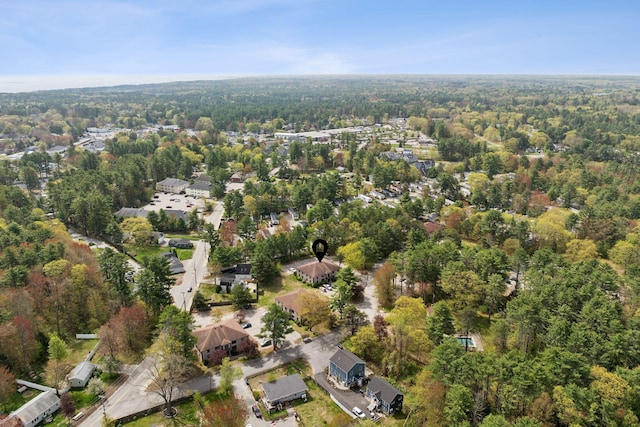 aerial view of property and surrounding area featuring a forest