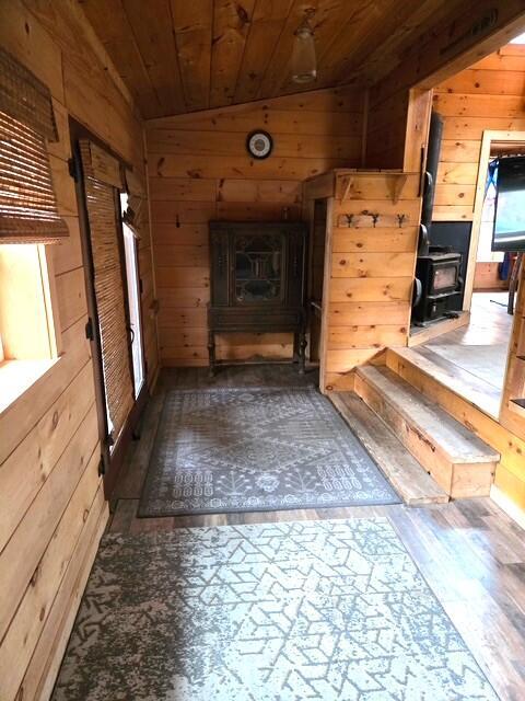 103 Fellows Ln, Winthrop, ME 04364 - hallway featuring wood walls, wooden ceiling, vaulted ceiling, and wood finished floors