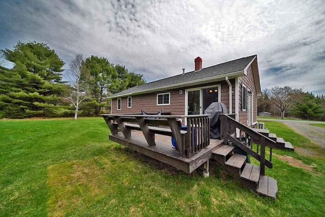 176 Smyrna Center Rd, Smyrna, ME 04780 - rear view of house featuring a chimney, a yard, and a deck