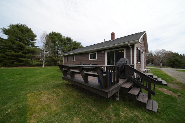 176 Smyrna Center Rd, Smyrna, ME 04780 - rear view of property with a chimney, a yard, a deck, and roof with shingles