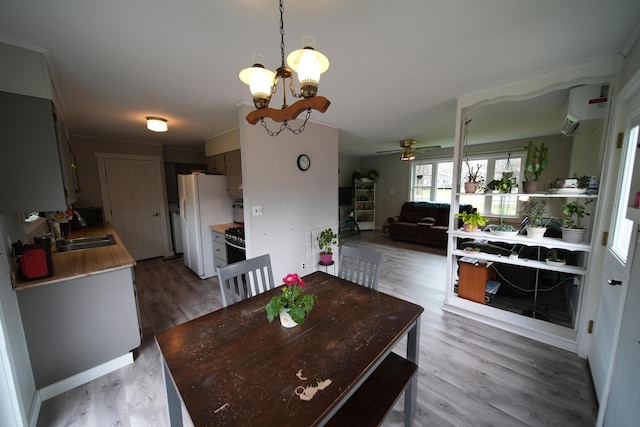 176 Smyrna Center Rd, Smyrna, ME 04780 - dining room featuring ceiling fan, a chandelier, and light wood finished floors