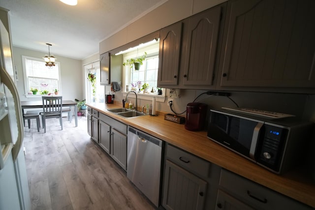 176 Smyrna Center Rd, Smyrna, ME 04780 - kitchen with stainless steel dishwasher, a sink, black microwave, wood finished floors, and healthy amount of natural light