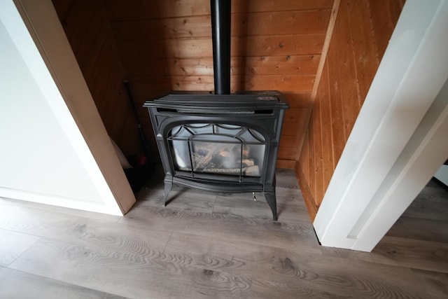 176 Smyrna Center Rd, Smyrna, ME 04780 - detailed view of wooden walls, a wood stove, and wood finished floors