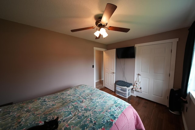 176 Smyrna Center Rd, Smyrna, ME 04780 - bedroom with dark wood-style flooring, ceiling fan, a closet, and baseboards