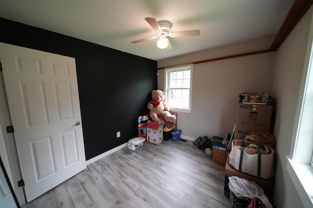 176 Smyrna Center Rd, Smyrna, ME 04780 - unfurnished bedroom featuring wood finished floors, a ceiling fan, baseboards, and a textured ceiling