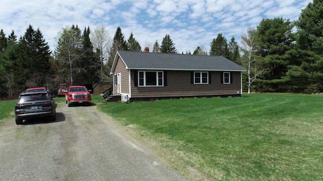 176 Smyrna Center Rd, Smyrna, ME 04780 - view of front of home featuring driveway, a chimney, a front lawn, and a shingled roof