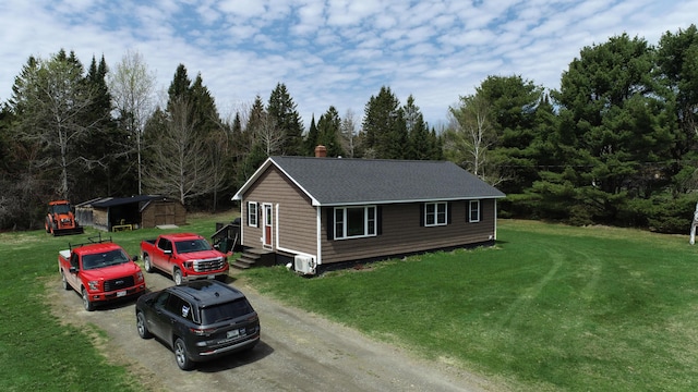 176 Smyrna Center Rd, Smyrna, ME 04780 - view of home's exterior featuring driveway, a chimney, a lawn, and an outbuilding