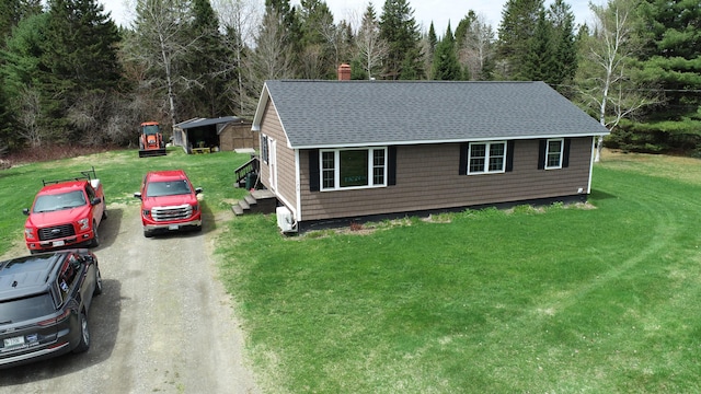 176 Smyrna Center Rd, Smyrna, ME 04780 - view of front of house with roof with shingles, dirt driveway, a front yard, and a chimney