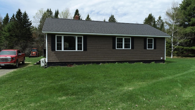 176 Smyrna Center Rd, Smyrna, ME 04780 - view of front of home with roof with shingles, a chimney, and a front lawn
