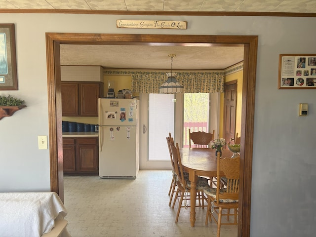 863 Sturtevant Hill Rd, Winthrop, ME 04364 - dining room featuring ornamental molding and light floors