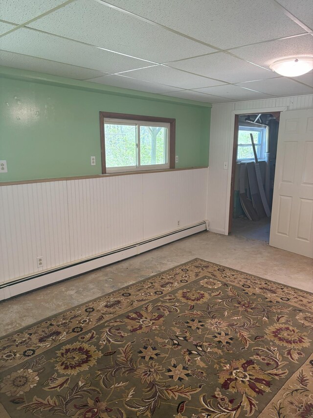 863 Sturtevant Hill Rd, Winthrop, ME 04364 - spare room with a baseboard radiator, wainscoting, a paneled ceiling, and wood walls