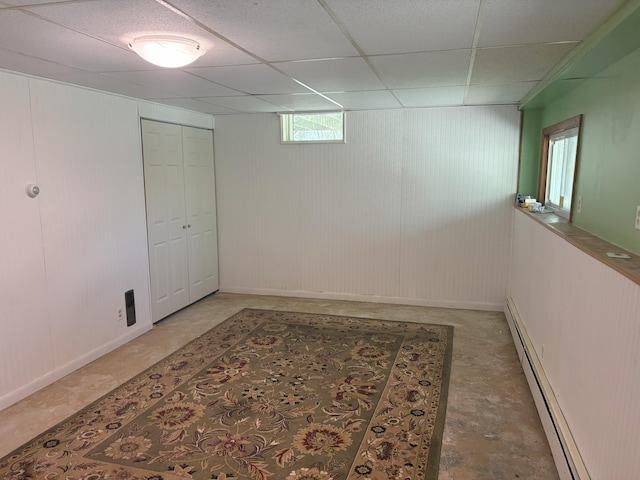 863 Sturtevant Hill Rd, Winthrop, ME 04364 - below grade area featuring a baseboard radiator, baseboards, and a paneled ceiling