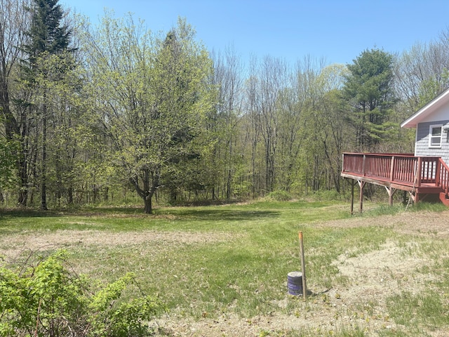 863 Sturtevant Hill Rd, Winthrop, ME 04364 - view of grassy yard featuring a deck and a wooded view