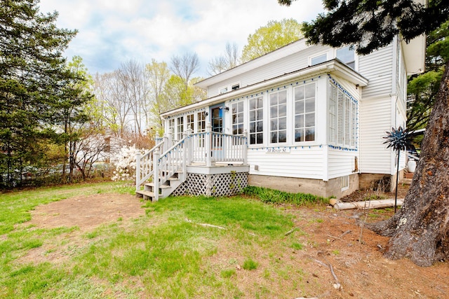10 River St, Strong, ME 04983 - back of property with a sunroom, a deck, and a yard