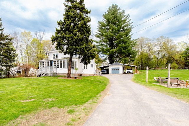 10 River St, Strong, ME 04983 - view of front of home with an outdoor structure, a front yard, asphalt driveway, a carport, and a garage