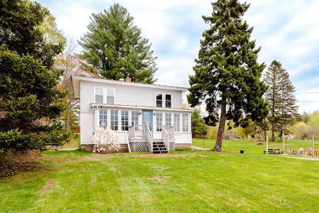 10 River St, Strong, ME 04983 - rear view of property featuring a sunroom, a lawn, a chimney, and a wooden deck