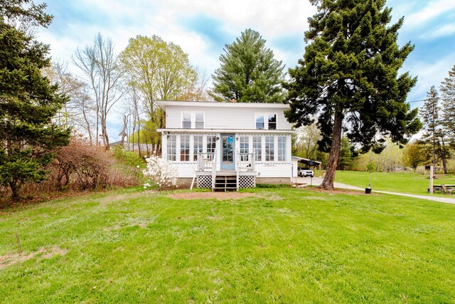 10 River St, Strong, ME 04983 - rear view of property with a wooden deck, a lawn, and a sunroom