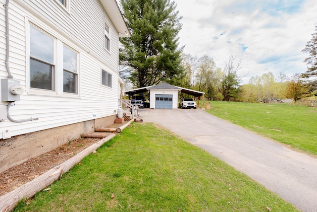 10 River St, Strong, ME 04983 - view of side of property with a lawn, a detached garage, driveway, and an outdoor structure