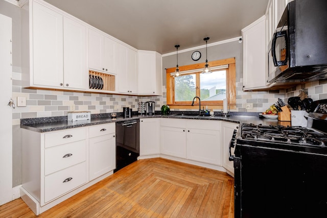 10 River St, Strong, ME 04983 - kitchen with black appliances, a sink, white cabinets, tasteful backsplash, and decorative light fixtures