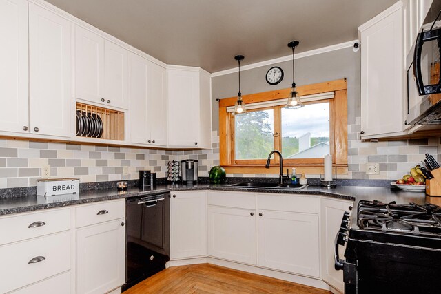 10 River St, Strong, ME 04983 - kitchen with black appliances, a sink, backsplash, and white cabinetry