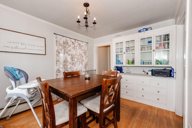 10 River St, Strong, ME 04983 - dining area with a chandelier, light wood-style flooring, and ornamental molding