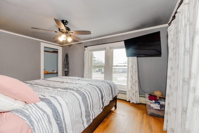 10 River St, Strong, ME 04983 - bedroom with crown molding, ceiling fan, a baseboard heating unit, and light wood finished floors