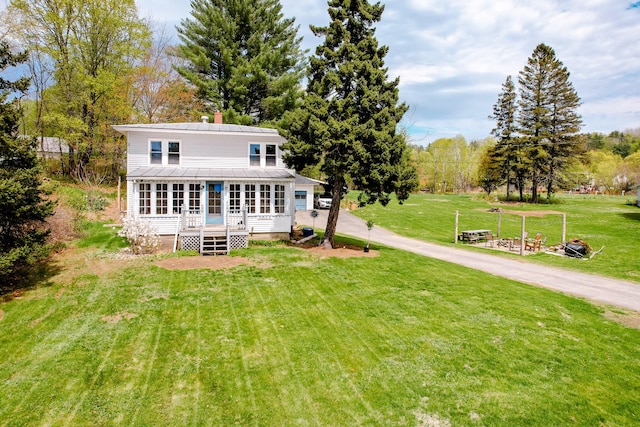 10 River St, Strong, ME 04983 - rear view of house featuring a deck, a lawn, metal roof, and a chimney