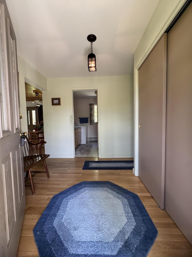 898 Sebec Village Rd, Sebec, ME 04481 - corridor with light wood-type flooring, plenty of natural light, and baseboards