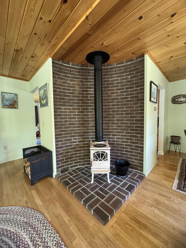 898 Sebec Village Rd, Sebec, ME 04481 - living area with a wood stove, wood-type flooring, wood ceiling, and baseboards