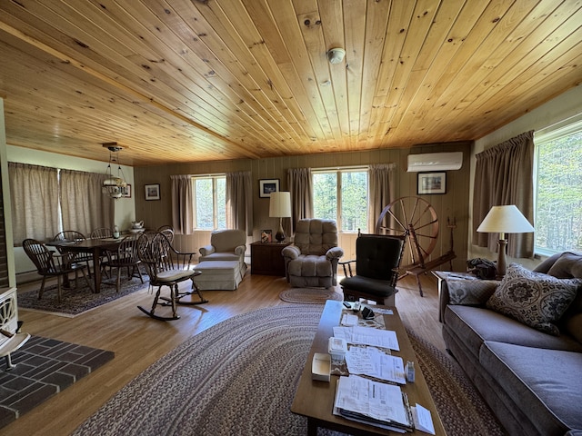 898 Sebec Village Rd, Sebec, ME 04481 - living area with a wall unit AC, plenty of natural light, wood finished floors, and wood ceiling