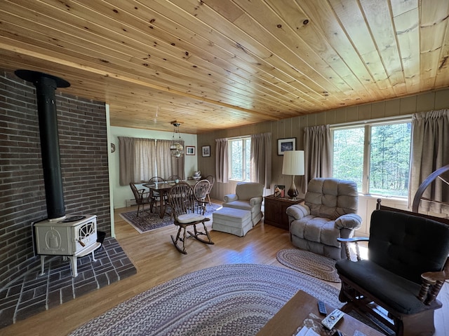898 Sebec Village Rd, Sebec, ME 04481 - living area with a wood stove, wooden ceiling, and wood finished floors