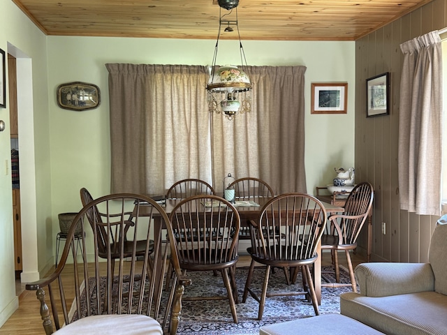 898 Sebec Village Rd, Sebec, ME 04481 - dining room featuring wood ceiling, wood finished floors, wood walls, and baseboards