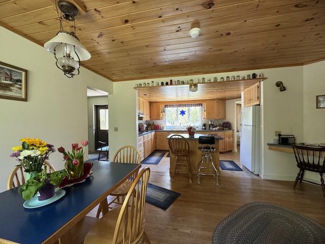 898 Sebec Village Rd, Sebec, ME 04481 - dining space with wood ceiling and dark wood-style flooring