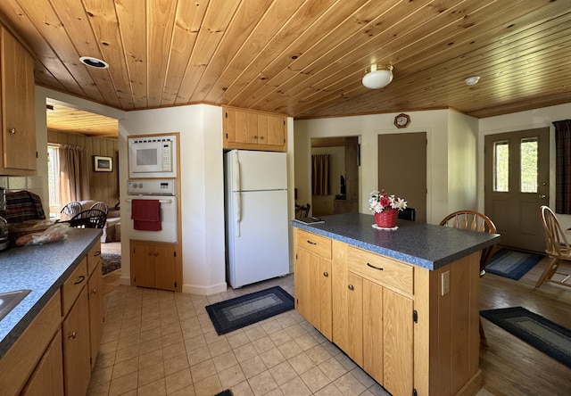 898 Sebec Village Rd, Sebec, ME 04481 - kitchen featuring white appliances, dark countertops, a center island, wooden ceiling, and light tile patterned floors
