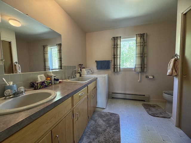 898 Sebec Village Rd, Sebec, ME 04481 - bathroom featuring baseboard heating, independent washer and dryer, toilet, and double vanity