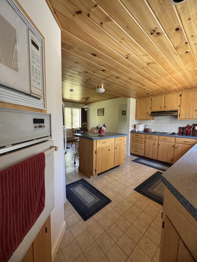 898 Sebec Village Rd, Sebec, ME 04481 - kitchen with dark countertops, white appliances, under cabinet range hood, wood ceiling, and light tile patterned floors