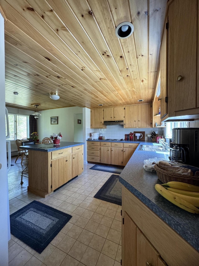 898 Sebec Village Rd, Sebec, ME 04481 - kitchen with dark countertops, a sink, light brown cabinets, wooden ceiling, and light tile patterned flooring