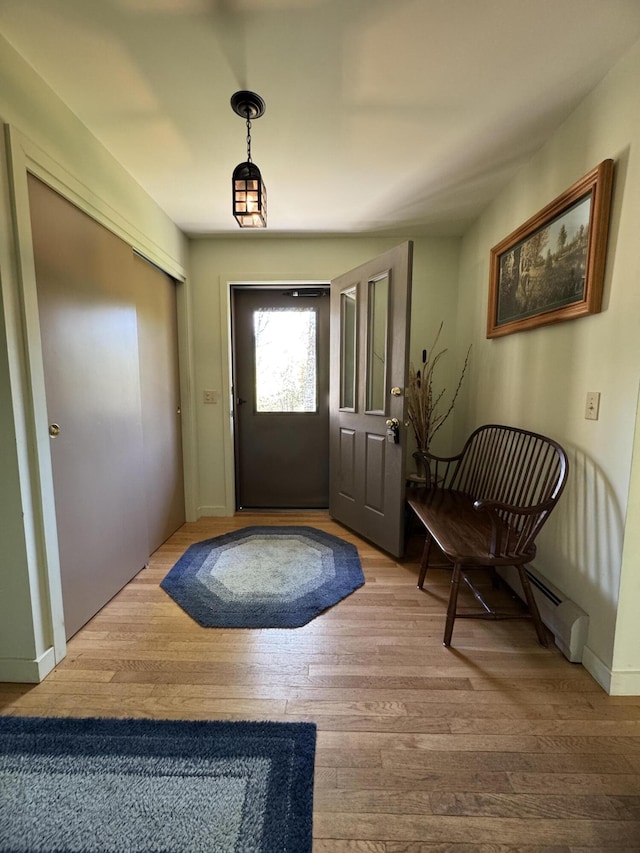 898 Sebec Village Rd, Sebec, ME 04481 - entryway with wood finished floors, a baseboard heating unit, and baseboards