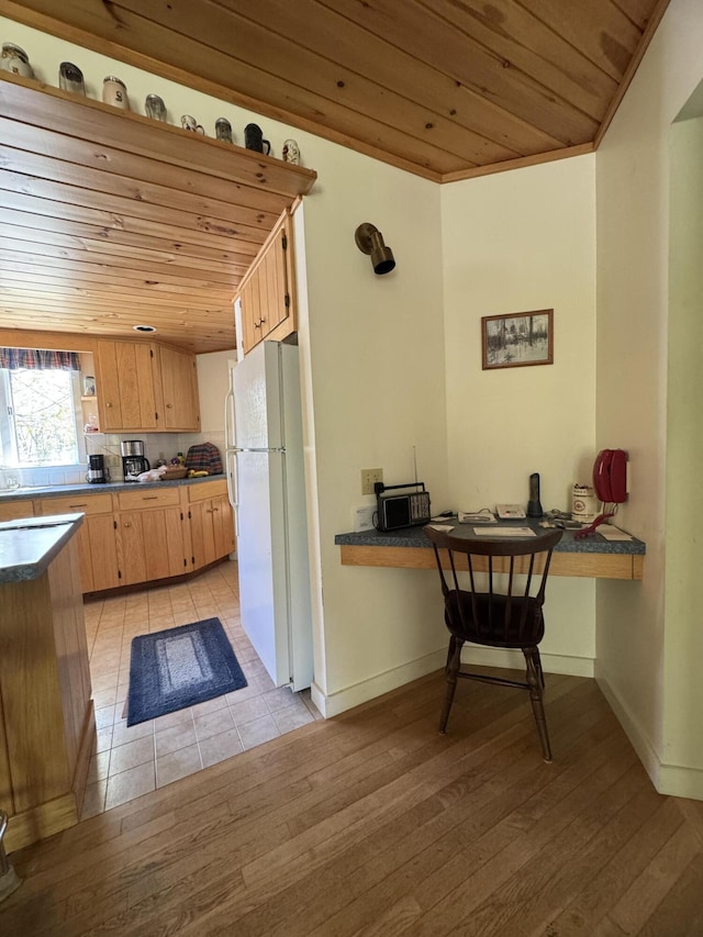 898 Sebec Village Rd, Sebec, ME 04481 - kitchen featuring freestanding refrigerator, wooden ceiling, dark countertops, and light wood-style flooring