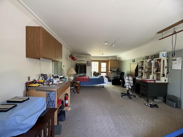898 Sebec Village Rd, Sebec, ME 04481 - bedroom with carpet flooring, vaulted ceiling, a desk, and an AC wall unit