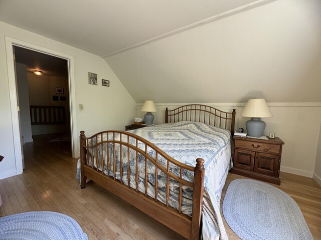 898 Sebec Village Rd, Sebec, ME 04481 - bedroom with hardwood / wood-style flooring, lofted ceiling, and baseboards