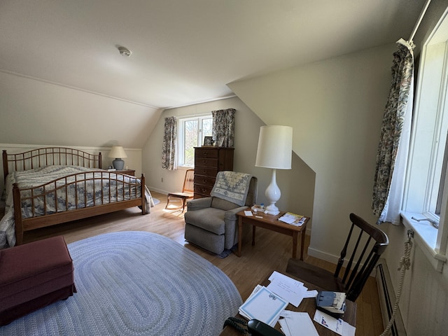 898 Sebec Village Rd, Sebec, ME 04481 - bedroom featuring wood finished floors, baseboards, and vaulted ceiling