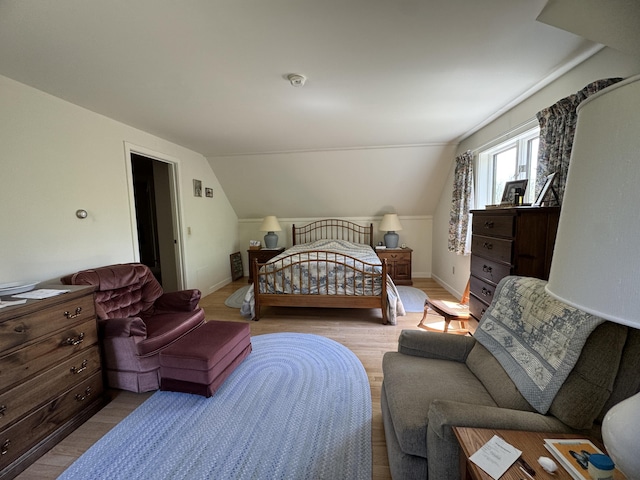 898 Sebec Village Rd, Sebec, ME 04481 - bedroom featuring lofted ceiling, wood finished floors, and baseboards