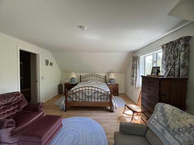 898 Sebec Village Rd, Sebec, ME 04481 - bedroom featuring wood finished floors, baseboards, and vaulted ceiling
