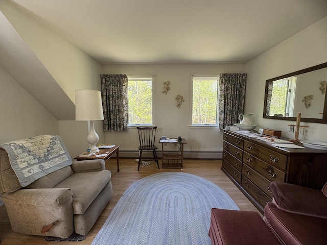 898 Sebec Village Rd, Sebec, ME 04481 - sitting room with light wood-type flooring and a baseboard heating unit