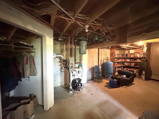 898 Sebec Village Rd, Sebec, ME 04481 - unfinished basement with a water pressure tank and a heating unit