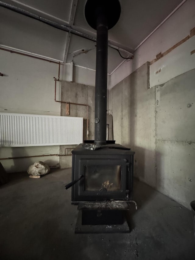 898 Sebec Village Rd, Sebec, ME 04481 - detailed view of concrete flooring and a wood stove