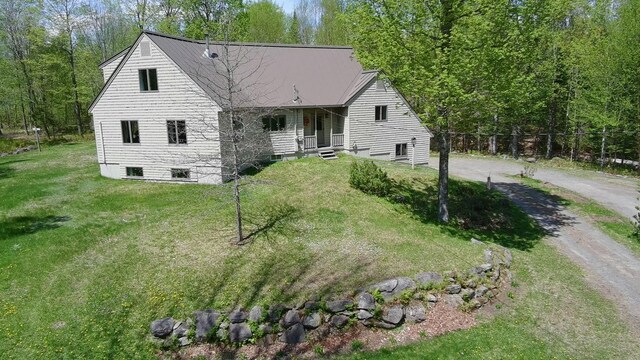 898 Sebec Village Rd, Sebec, ME 04481 - view of front of property with dirt driveway and a front lawn
