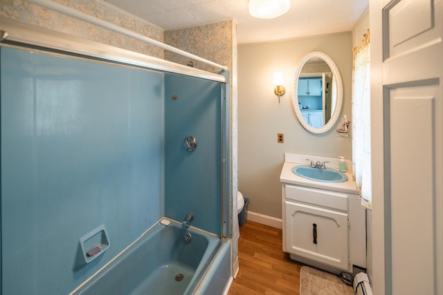 168 Beech Hill Rd, Auburn, ME 04210 - bathroom with vanity, a baseboard radiator, shower / bathtub combination, wood finished floors, and toilet