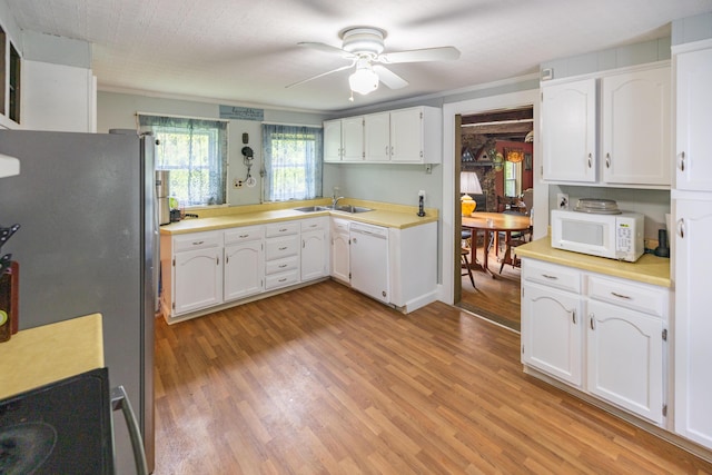 168 Beech Hill Rd, Auburn, ME 04210 - kitchen featuring white appliances, a sink, light wood finished floors, a ceiling fan, and white cabinetry